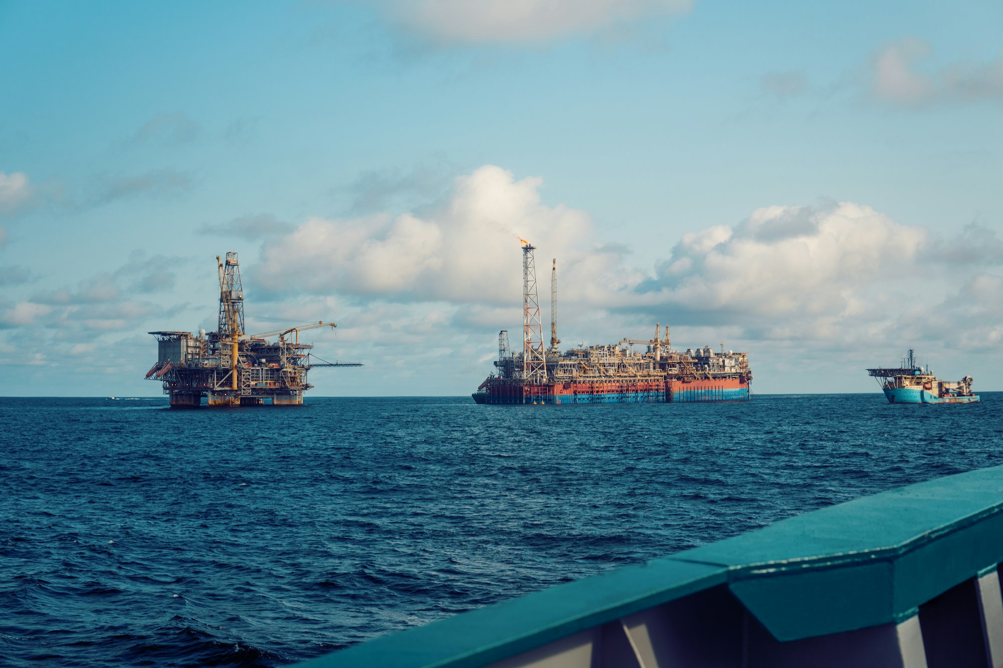 FPSO tanker vessel near Oil Rig platform. Offshore oil and gas industry